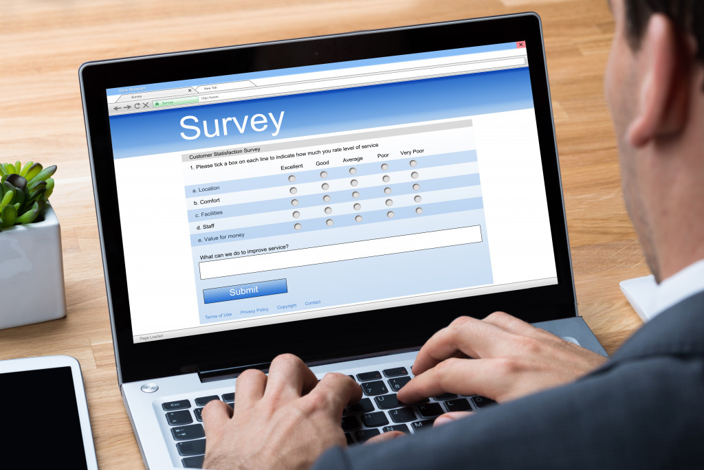 an employee using a laptop answering a survey form